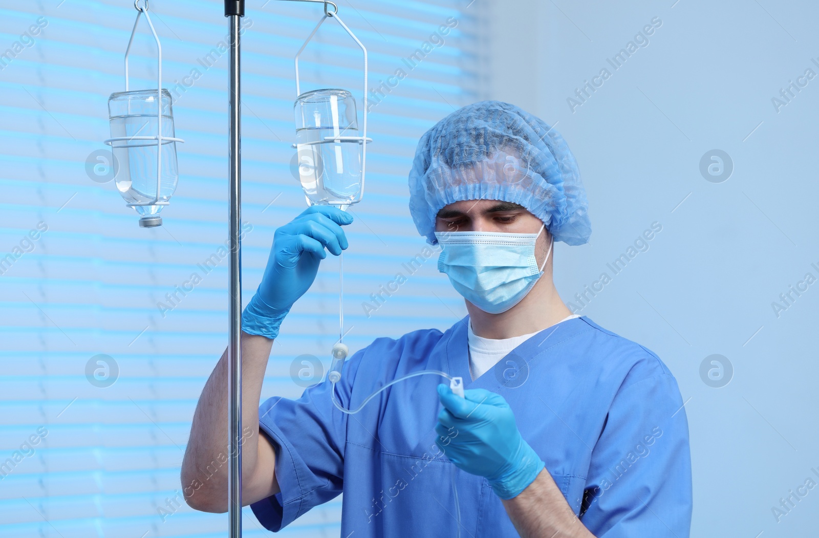 Photo of Nurse setting up IV drip in hospital