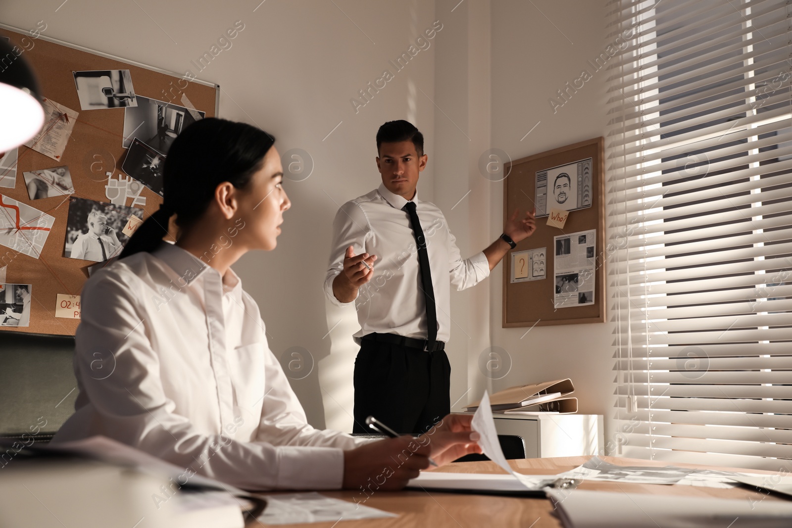 Photo of Professional detectives working on case in office