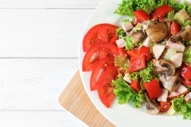 Photo of Plate with delicious fresh salad on table, top view