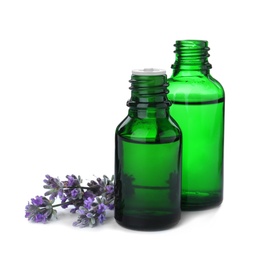 Photo of Bottles of essential oil and lavender flowers isolated on white