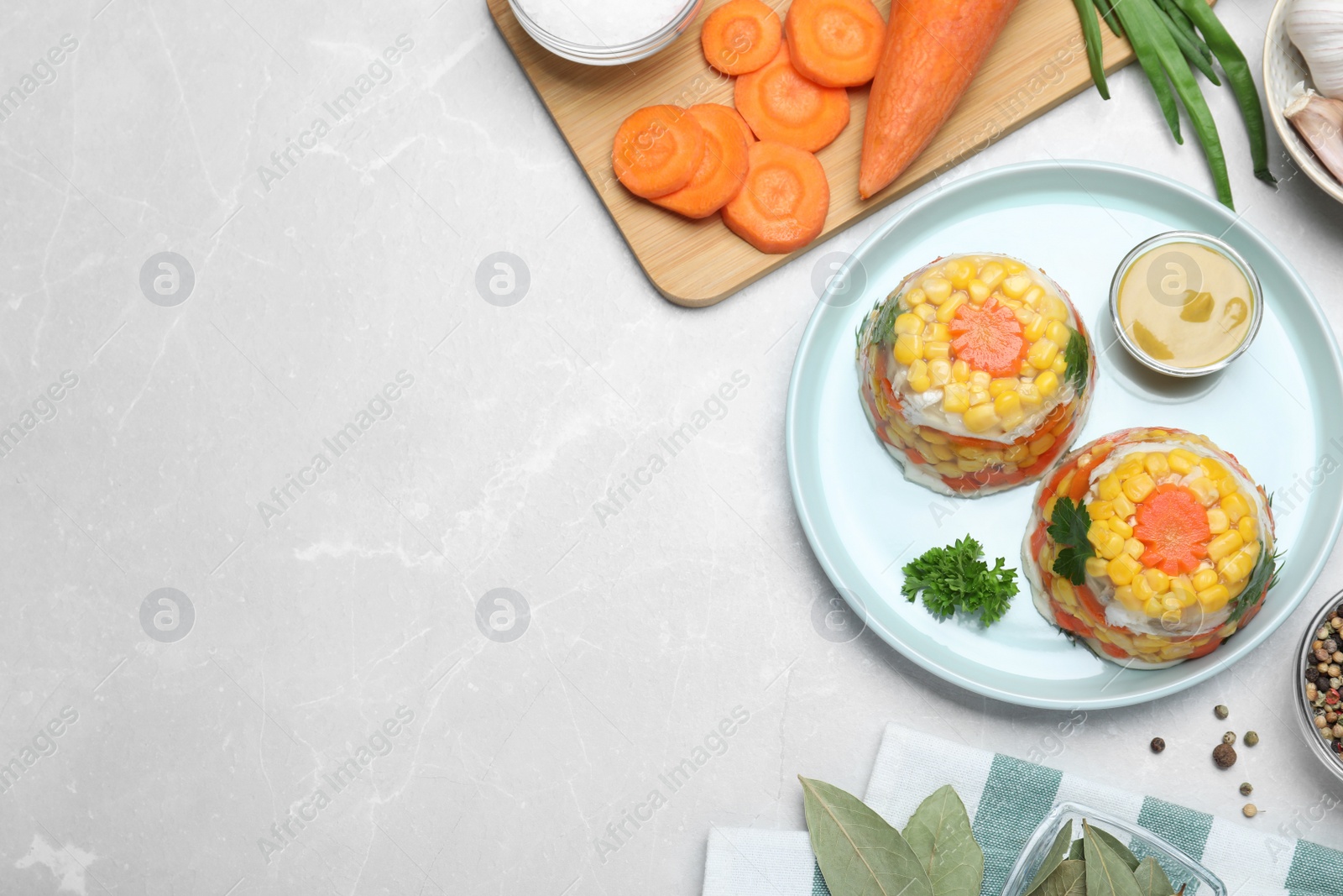 Photo of Delicious fish aspic served on light table, flat lay. Space for text