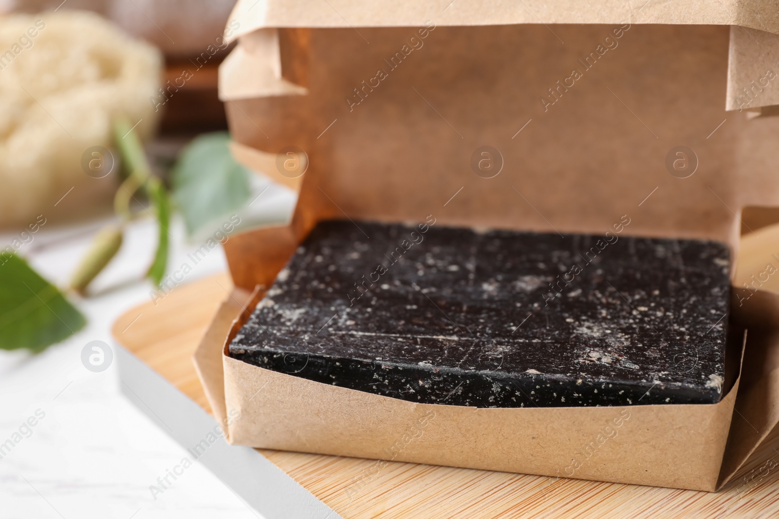 Photo of Tar soap packed in kraft paper, closeup. Natural product