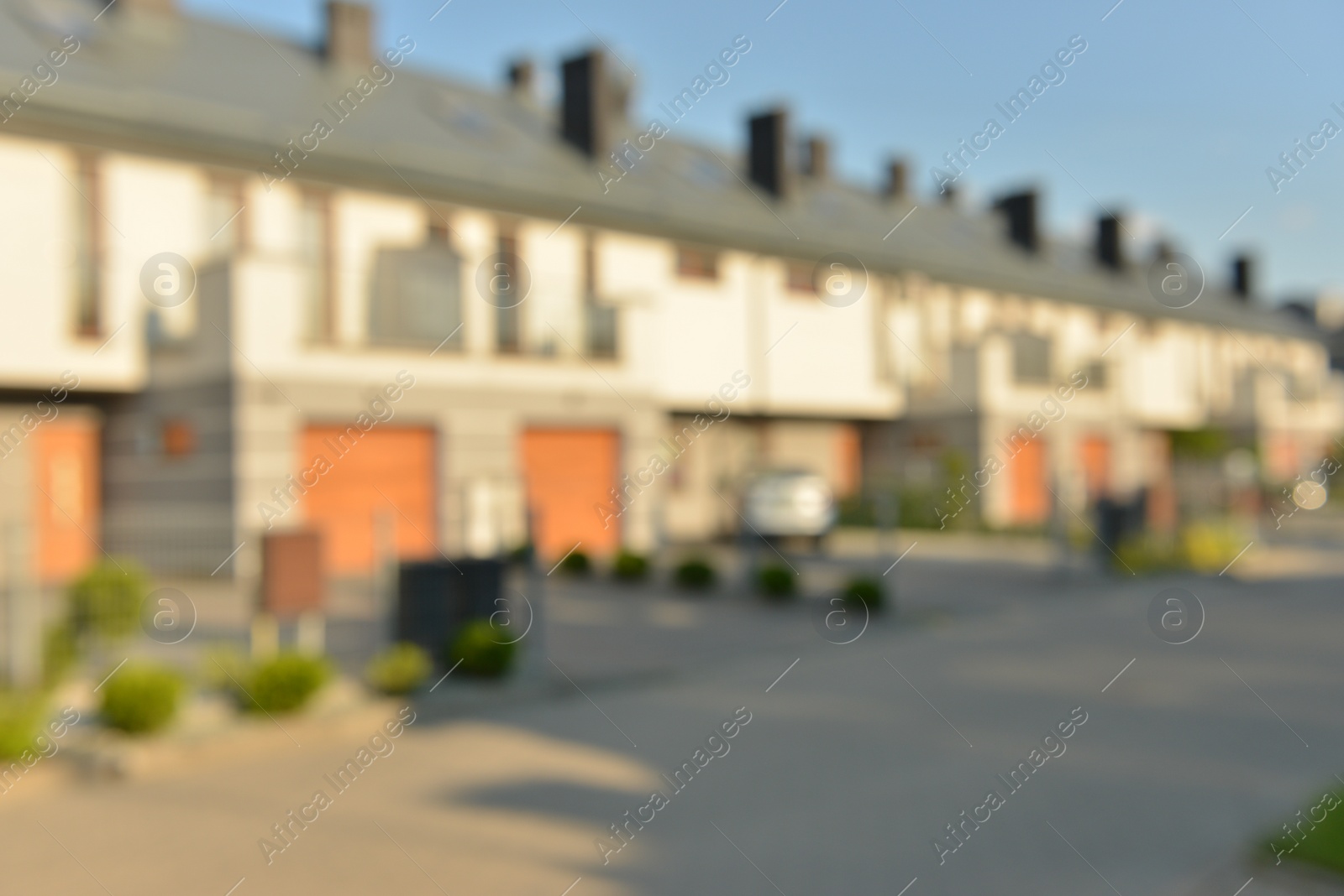 Photo of Blurred view of suburban street with beautiful houses