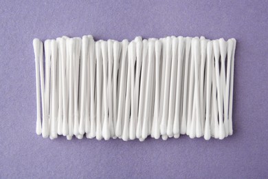 Photo of Many clean cotton buds on blue background, flat lay