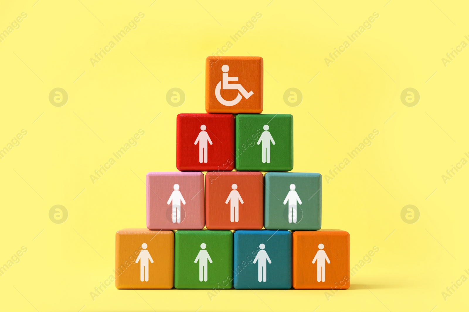 Image of Inclusive workplace culture. Pyramid of colorful cubes with human icons and one with international symbol of access on yellow background