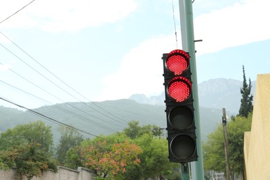 Photo of Traffic lights and beautiful mountains on background, space for text
