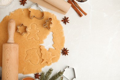 Photo of Flat lay composition with dough and cookie cutters on white table, space for text. Christmas biscuits