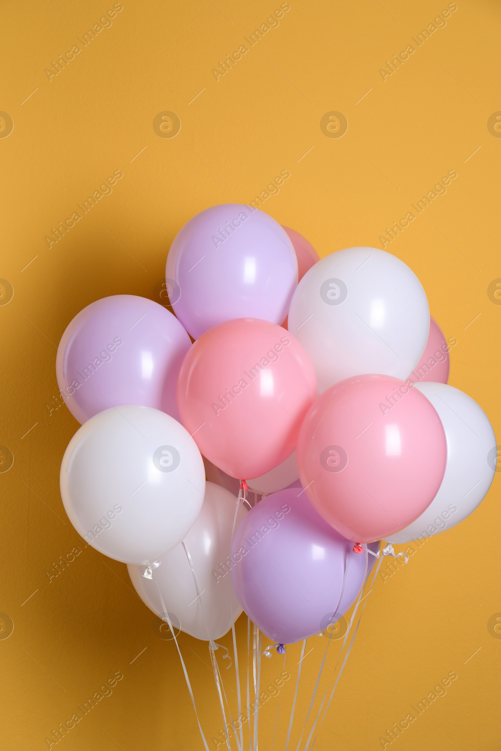 Photo of Different helium party balloons on color background