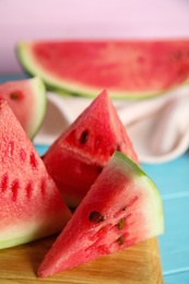 Photo of Yummy watermelon slices on wooden board, closeup