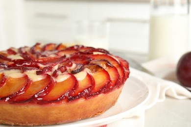 Delicious cake with plums on plate, closeup