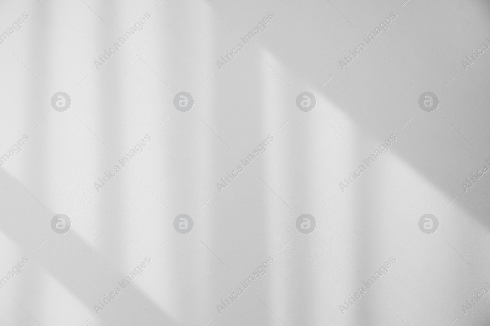 Photo of Shadow from window and curtains on white wall indoors