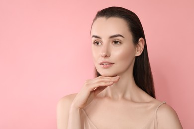 Portrait of beautiful young woman on pink background. Space for text
