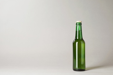 Bottle of beer on grey background. Space for text