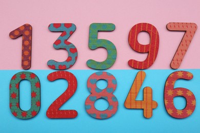 Photo of Wooden numbers on colorful background, flat lay