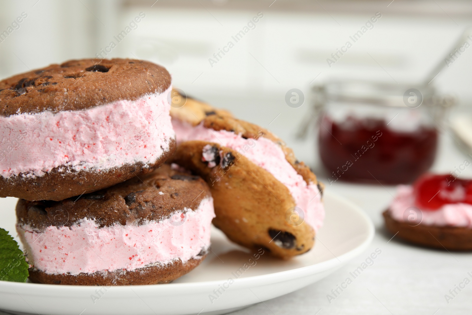 Photo of Sweet delicious ice cream cookie sandwiches on plate, closeup. Space for text