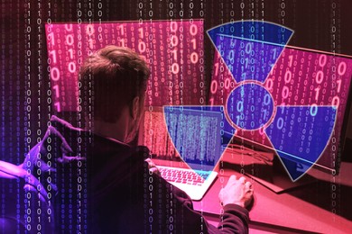 Image of Nuclear deterrence. Hacker using computers, binary code and warning radiation symbol