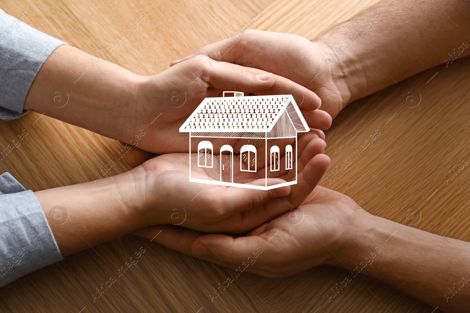 Image of Home security concept. Couple holding house indoors, closeup