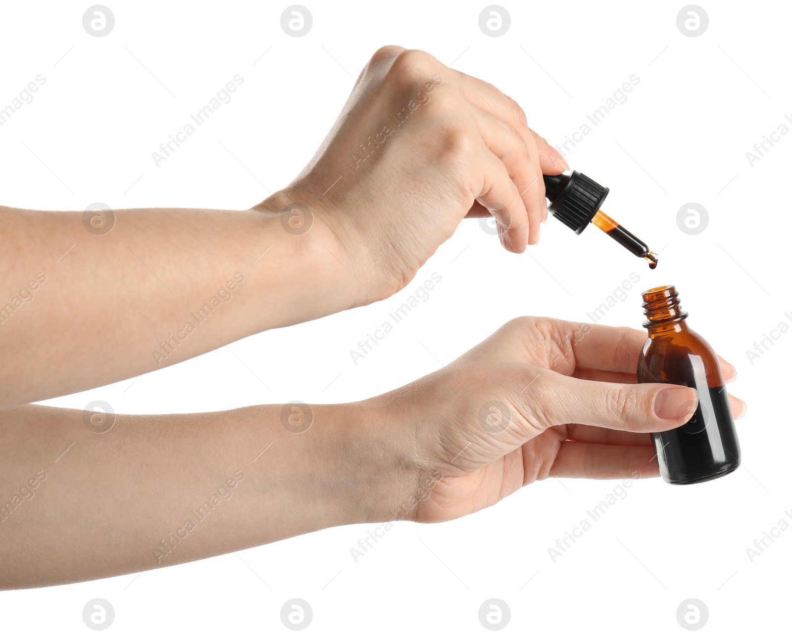 Photo of Woman dripping medical iodine into bottle on white background, closeup