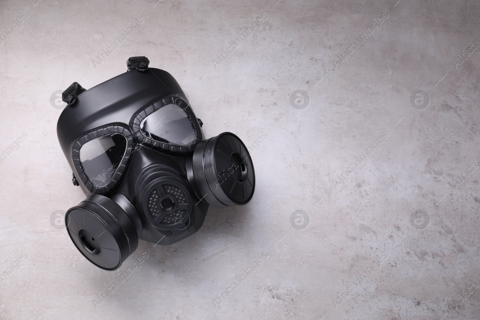 Photo of One gas mask on grey textured background, top view. Space for text