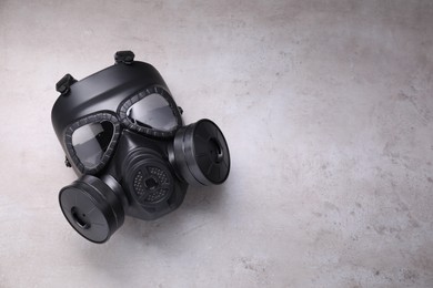 Photo of One gas mask on grey textured background, top view. Space for text