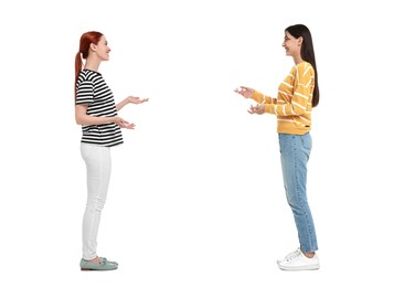Two women talking on white background. Dialogue