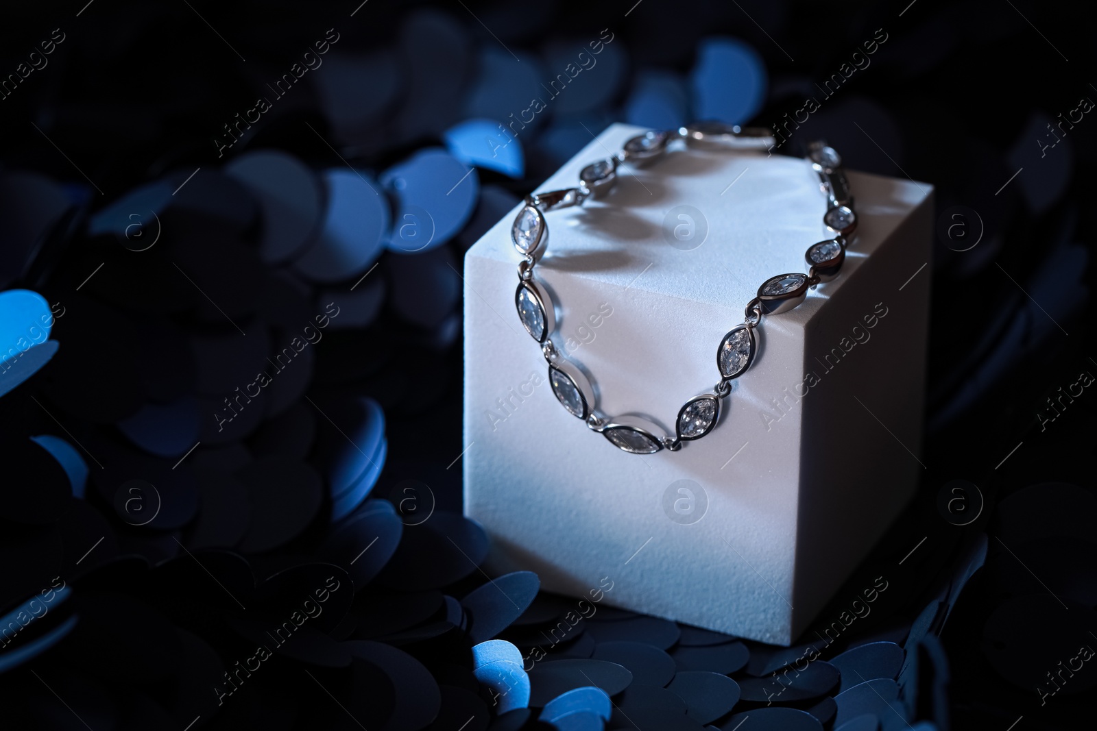 Photo of Elegant jewelry. Stylish presentation of luxury bracelet on podium. Space for text