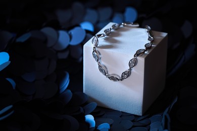 Elegant jewelry. Stylish presentation of luxury bracelet on podium. Space for text