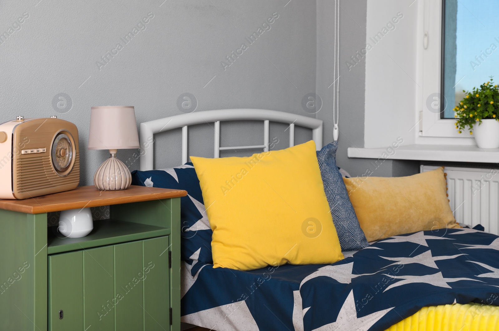 Photo of Stylish child room interior with comfortable bed near window