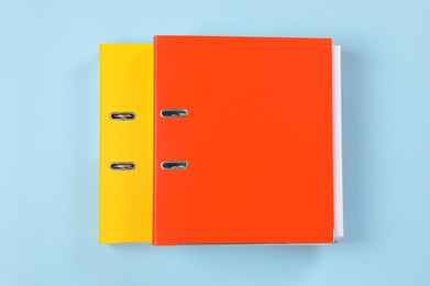 Photo of Office folders on light blue background, flat lay