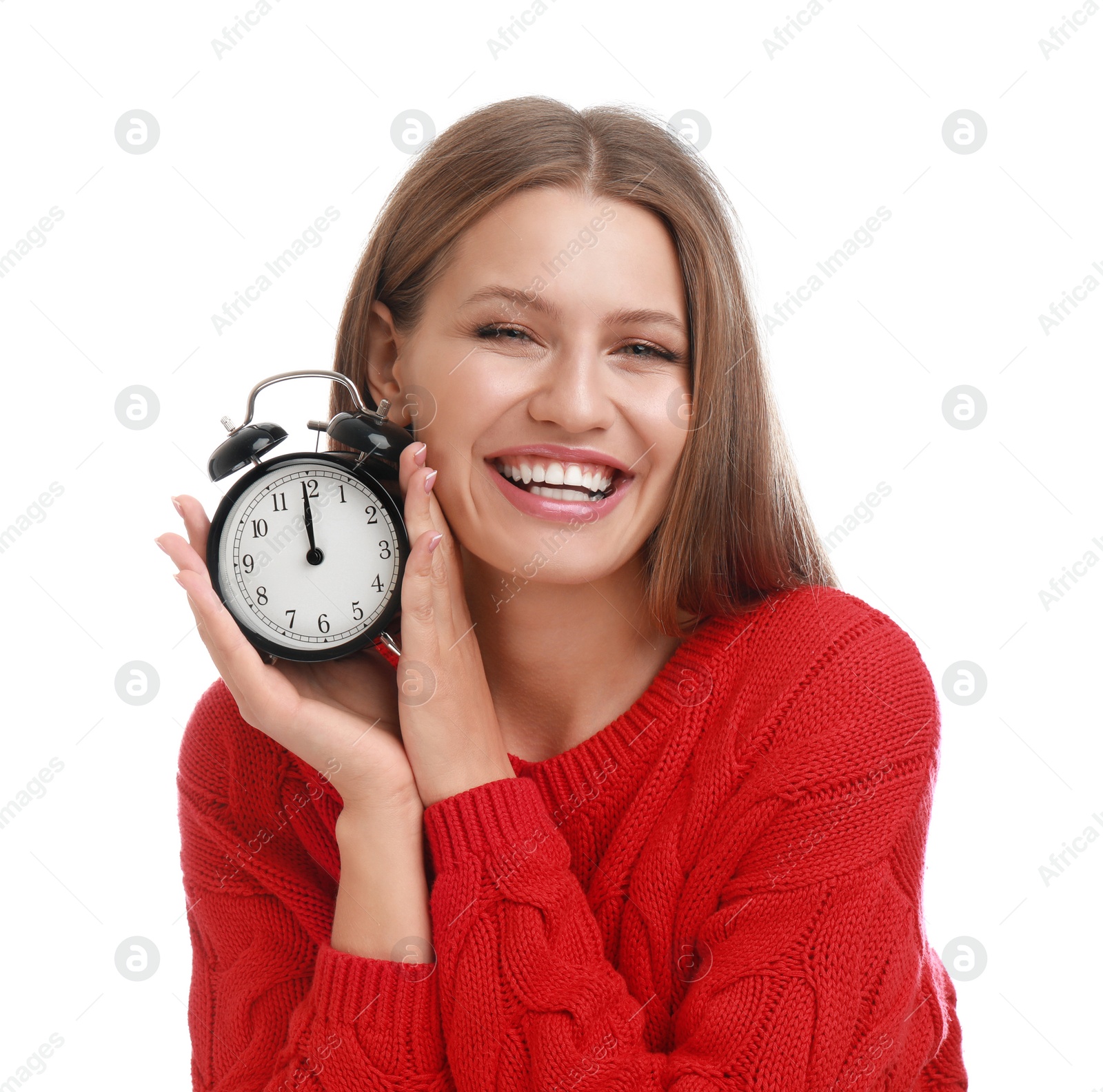 Photo of Happy young woman with alarm clock on white background. Christmas time