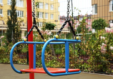 Photo of Swing on outdoor playground in residential area