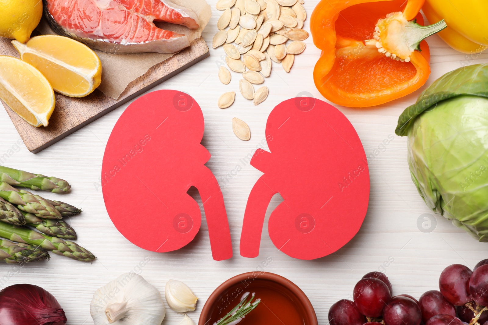 Photo of Flat lay composition with paper cutout of kidneys and different products on white wooden table