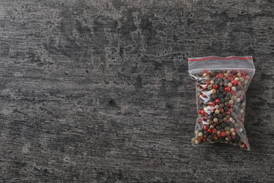 Photo of Plastic bag with spice on grey background, top view
