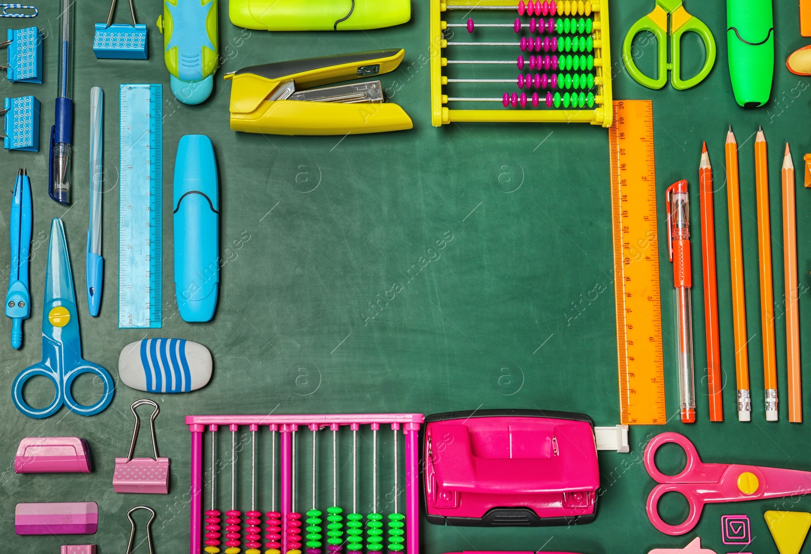 Photo of Flat lay composition with different school stationery on chalkboard surface