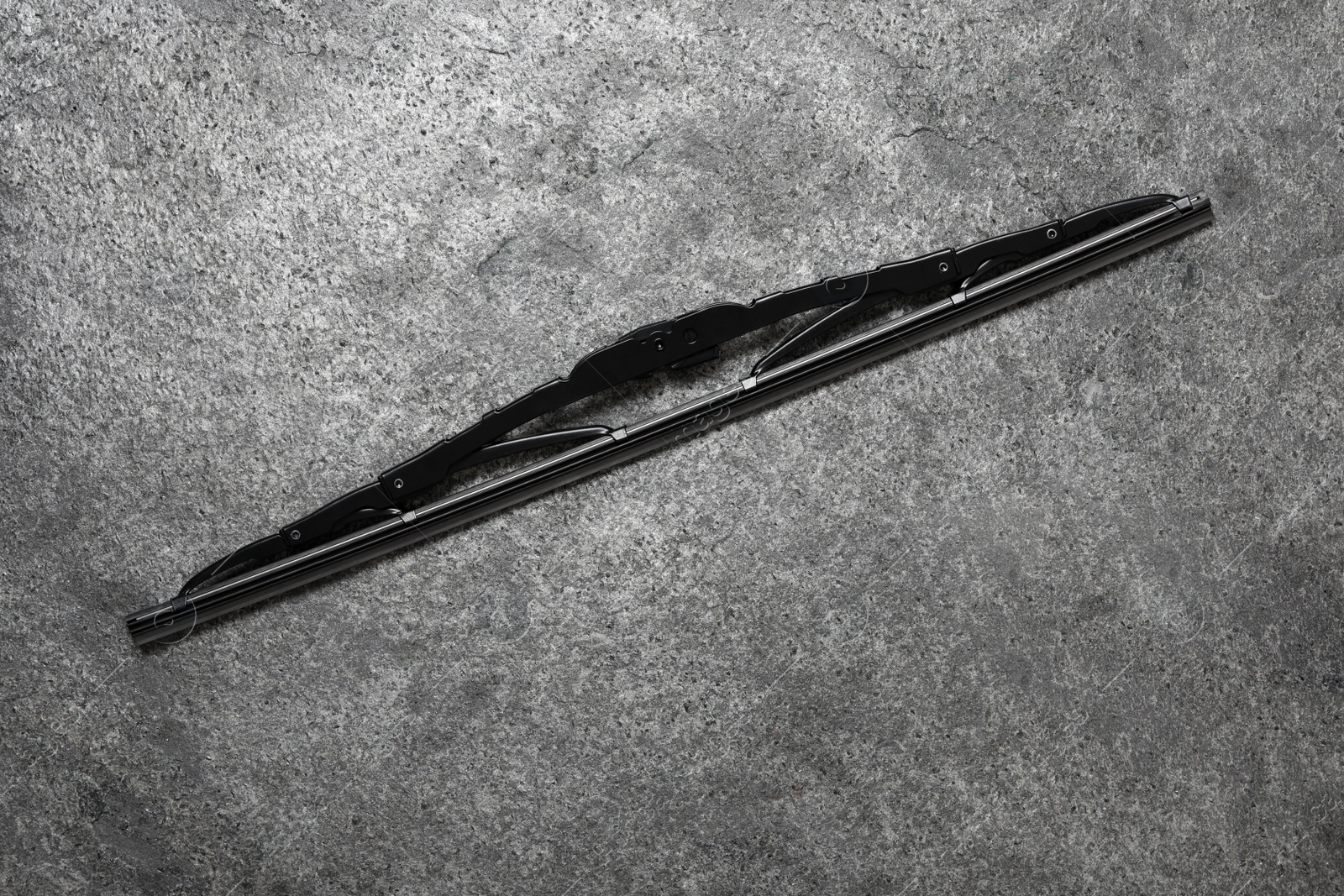 Photo of Car windshield wiper on grey stone background