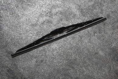 Car windshield wiper on grey stone background