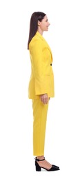 Businesswoman in yellow suit standing on white background