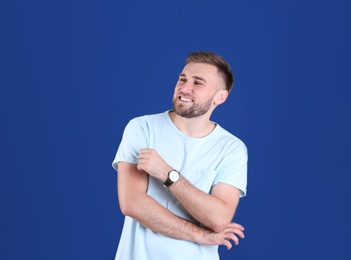 Photo of Portrait of handsome happy man on color background