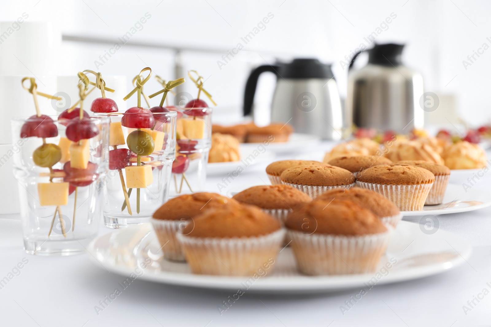 Photo of Table with different delicious snacks indoors. Coffee break