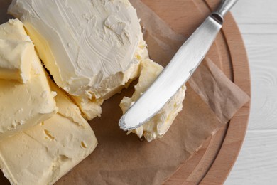 Tray with tasty homemade butter and knife on white wooden table, top view