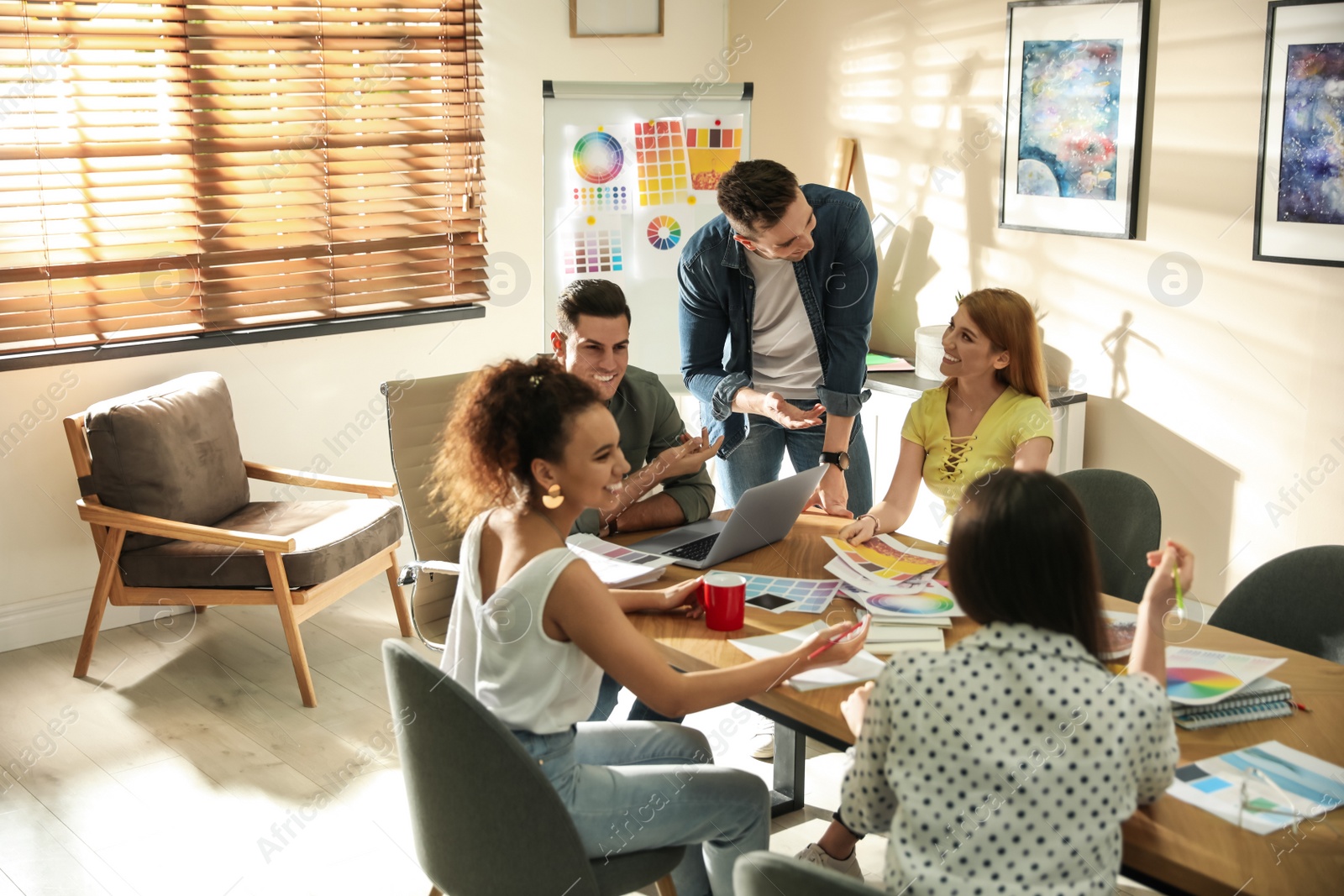 Photo of Team of professional designers working in office