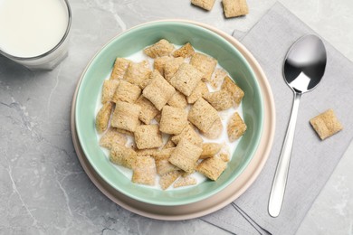 Photo of Bowl with tasty corn pads and milk on light grey marble table, flat lay