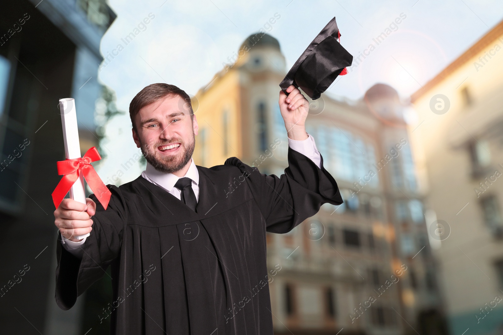 Image of Happy student with graduation hat and diploma outdoors