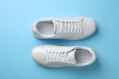 Photo of Pair of sneakers on color background, flat lay