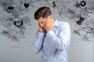 Stressed man with mess in his head on grey background