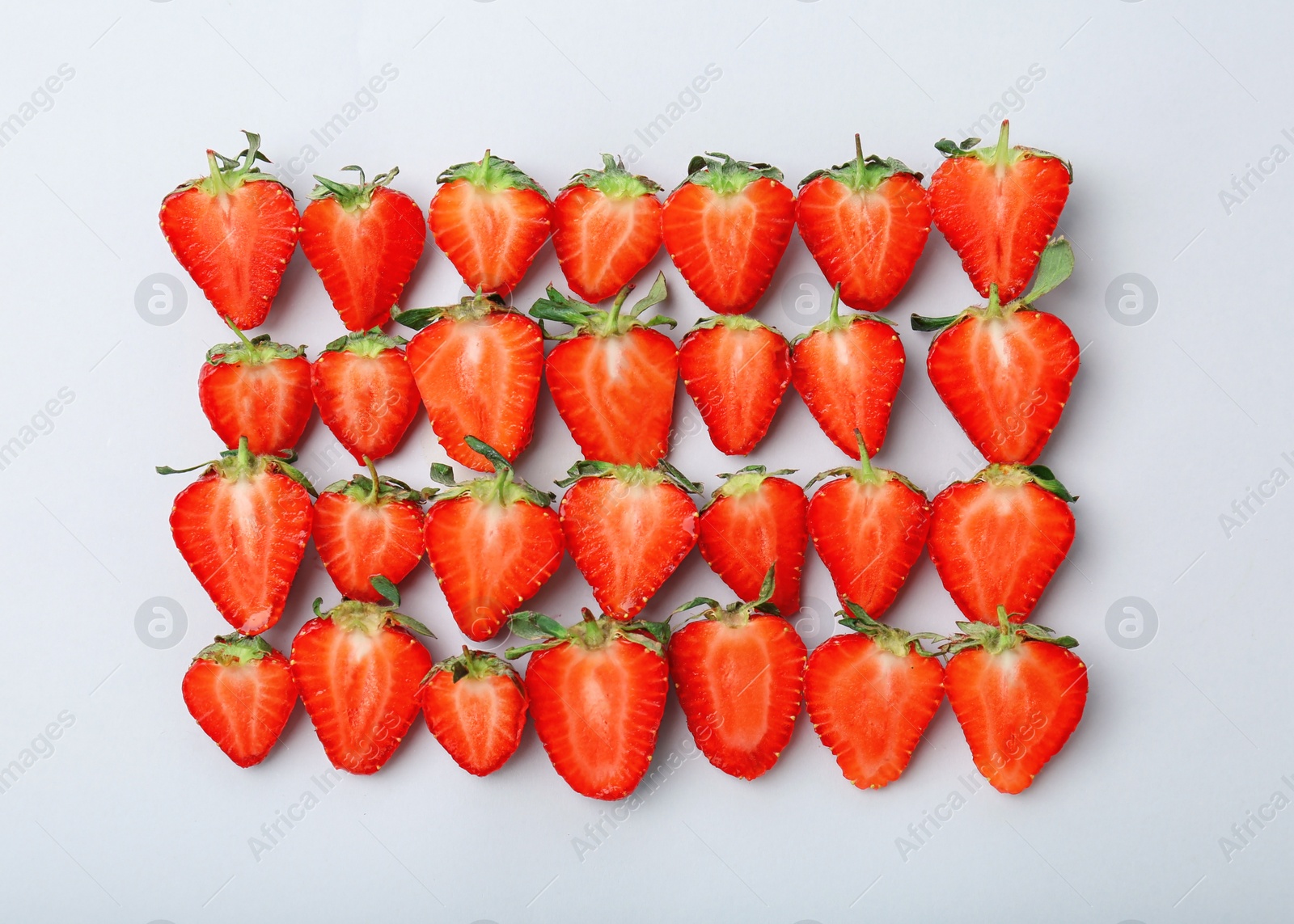 Photo of Flat lay composition with ripe red strawberries on light background