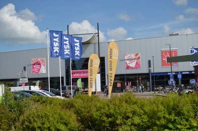Photo of Winschoten, Netherlands - June 02, 2022: Shopping mall on city street