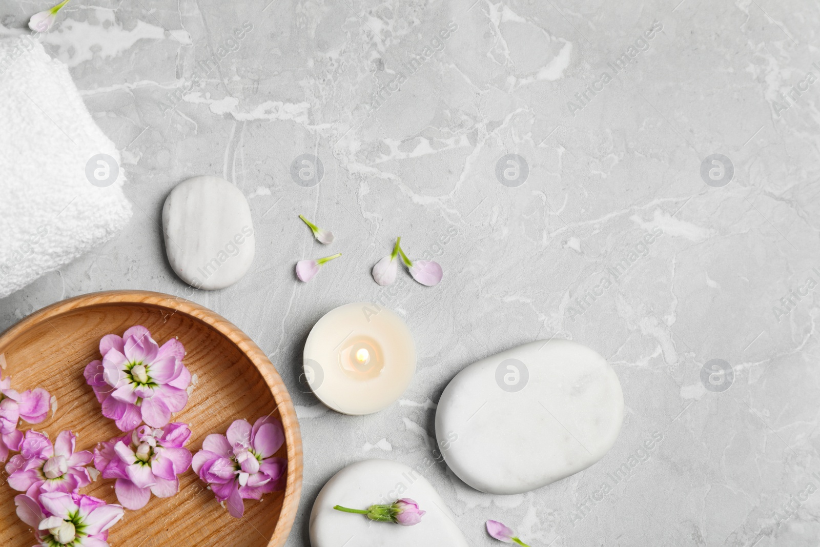 Photo of Flat lay composition with spa stones on light grey marble table, space for text