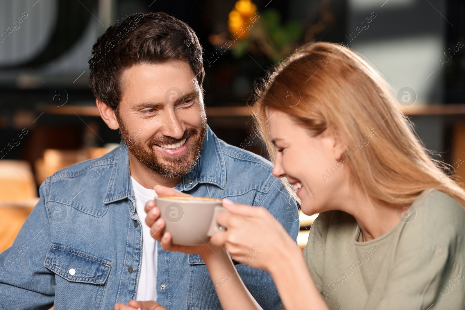 Photo of Romantic date. Happy couple spending time together in cafe