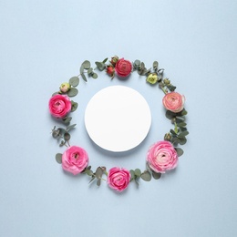 Photo of Frame of beautiful ranunculus flowers and paper card  on light blue background, flat lay. Space for text